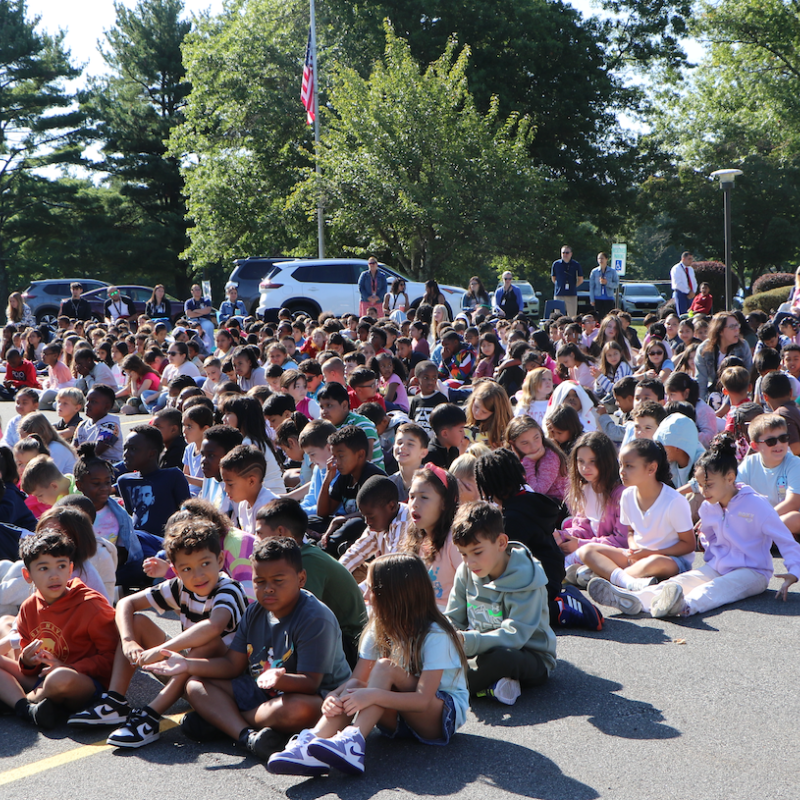 students sitting in an assembly