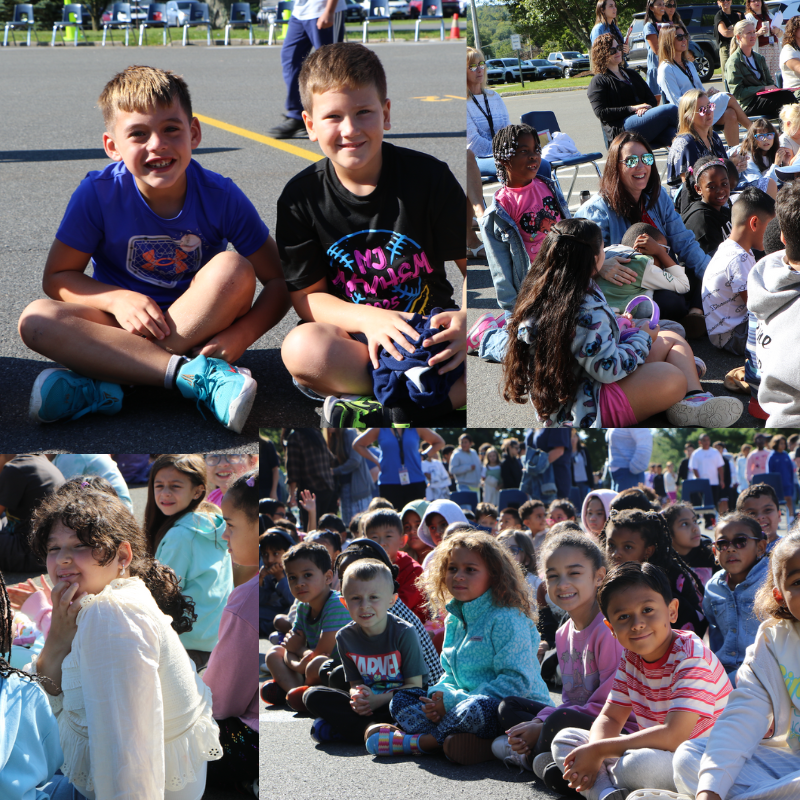 students sitting on playground for an assembly