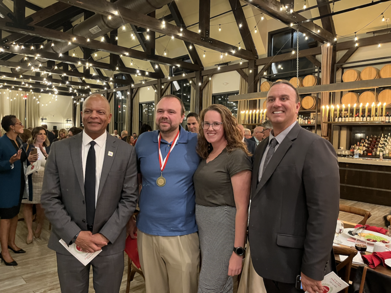 four people standing together