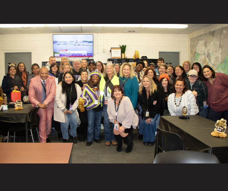 bus garage staff kneeling for photo