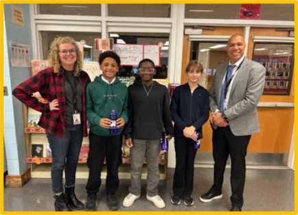 three students with two administrators wearing yellow and grey