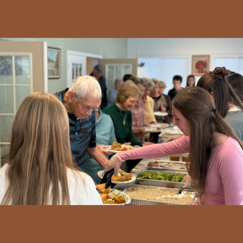 woman with pink shirt serving food
