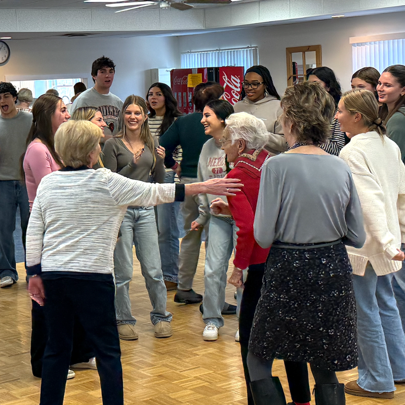 people dancing on a brown floor