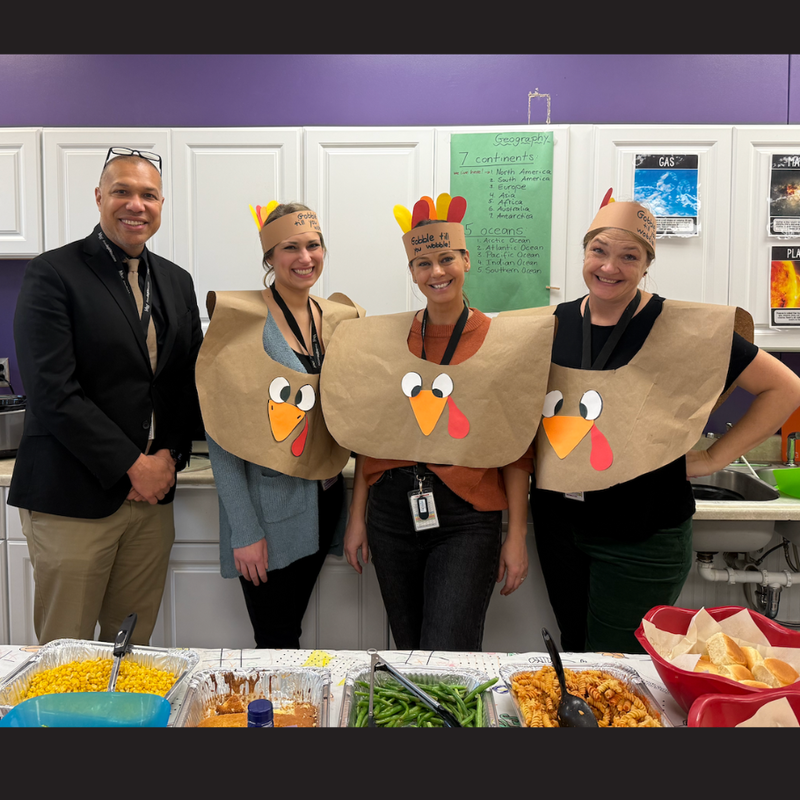four people wearing turkey costume
