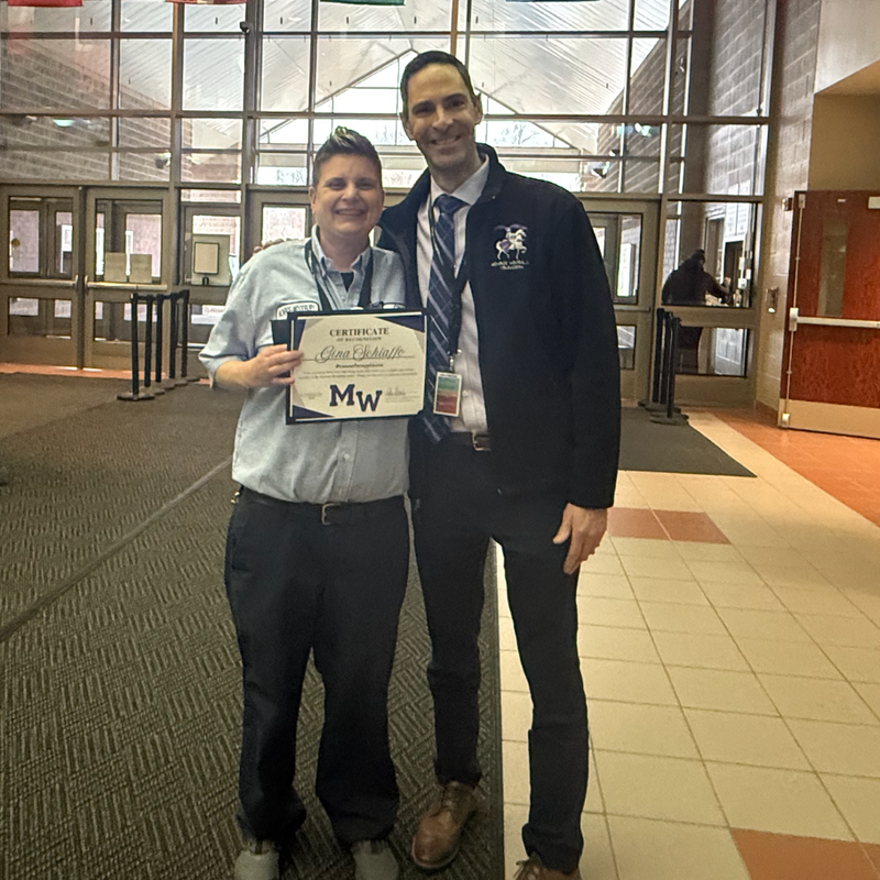 man and woman standing wearing blue shirts