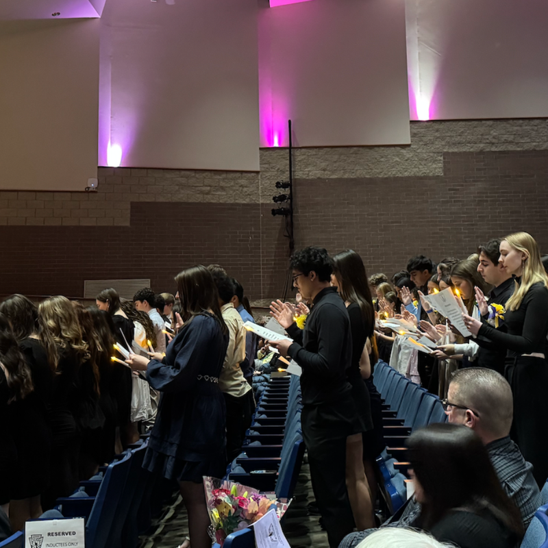 students standing in auditorium