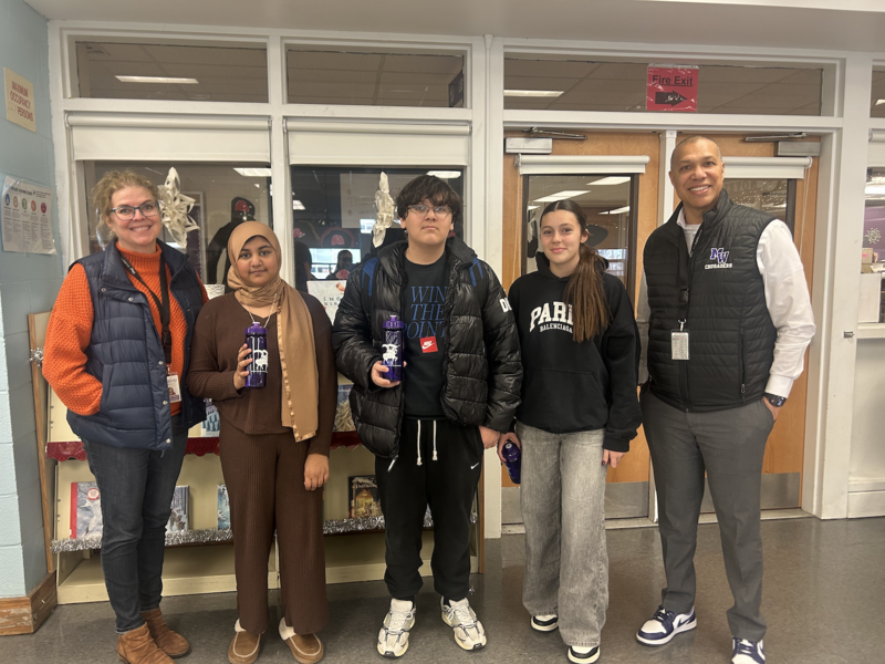 five people standing in room