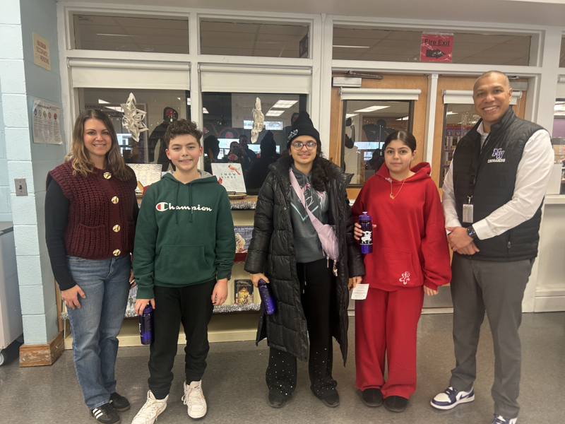 five people standing in a room