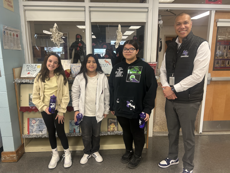 four people standing in a room