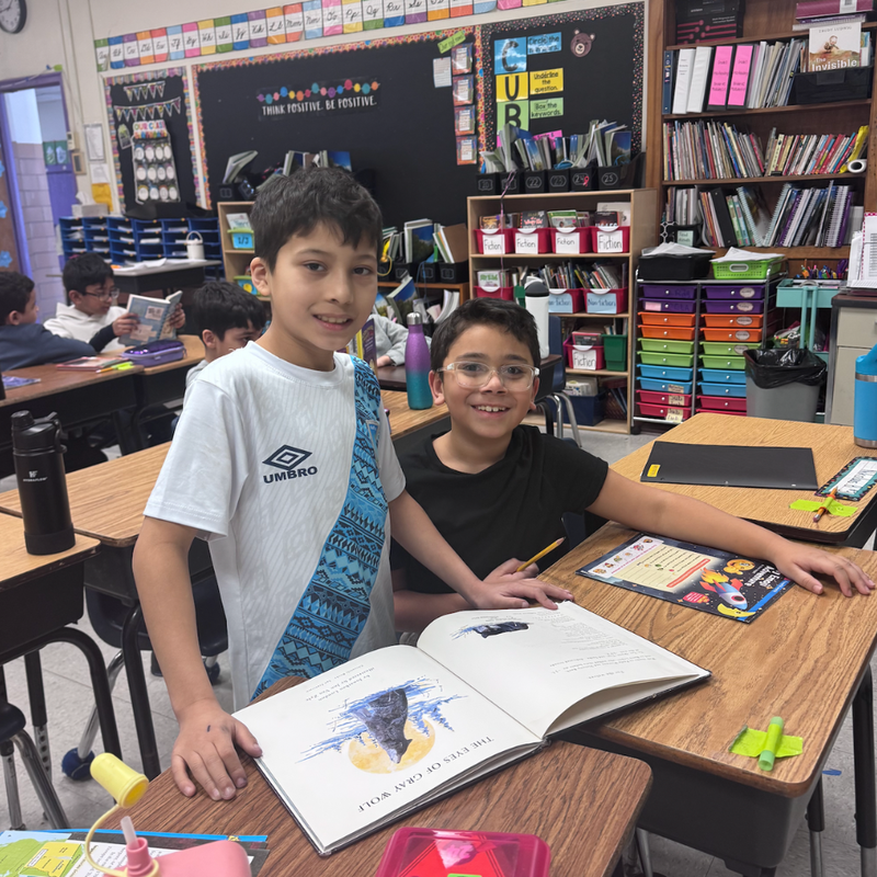 students sitting a  desk 