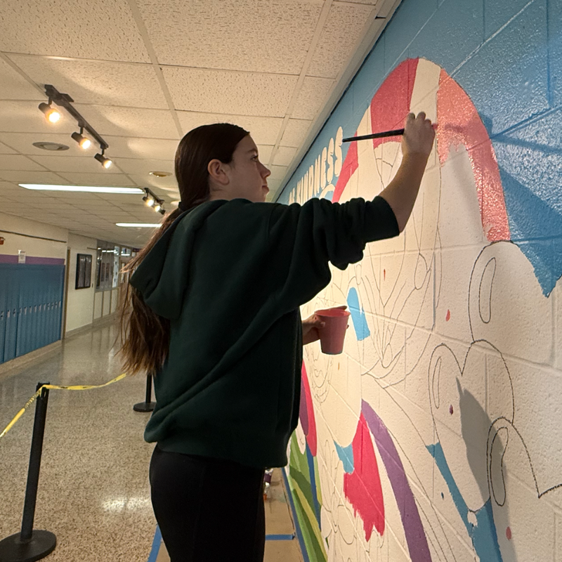 student painting a wall