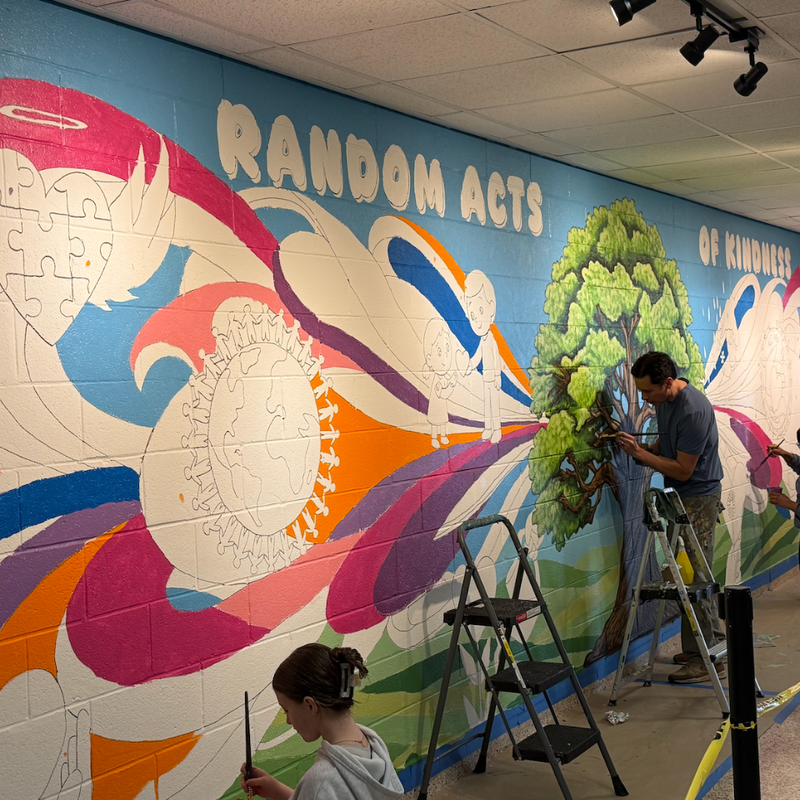 students painting a wall