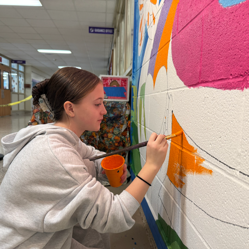 student painting a wall