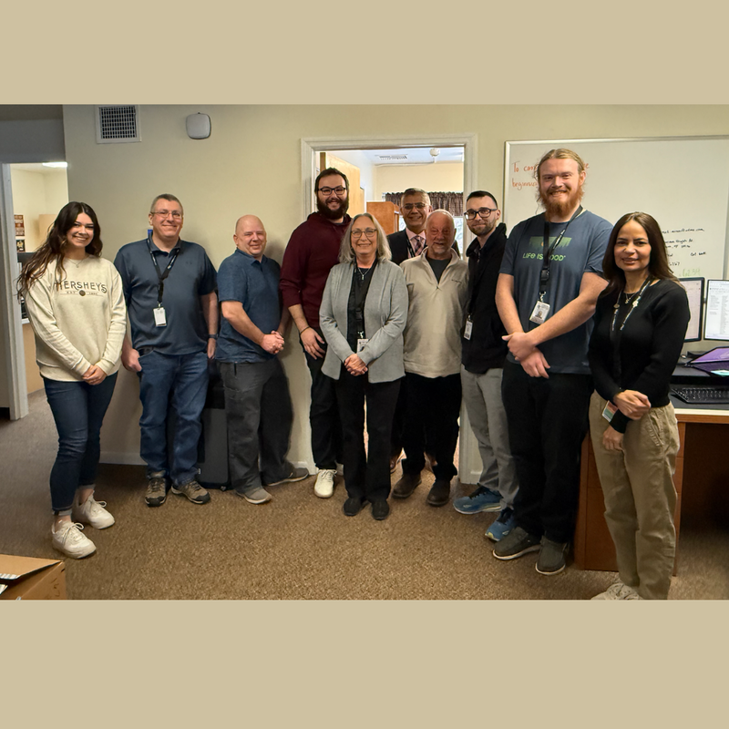 10 people standing in an office