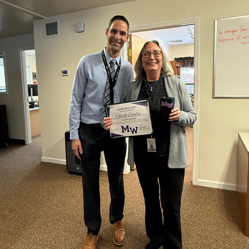 two people standing in an office 
