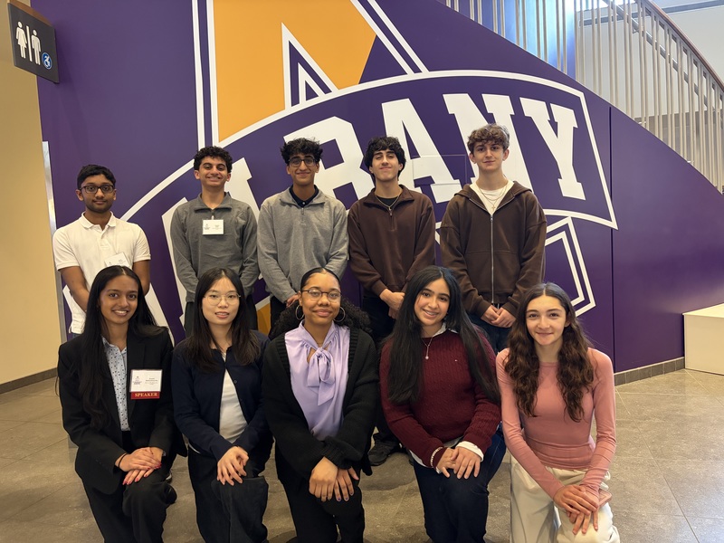 science students in front of ualbany sign