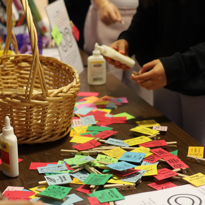 display of small pieces of paper next to a bakset 