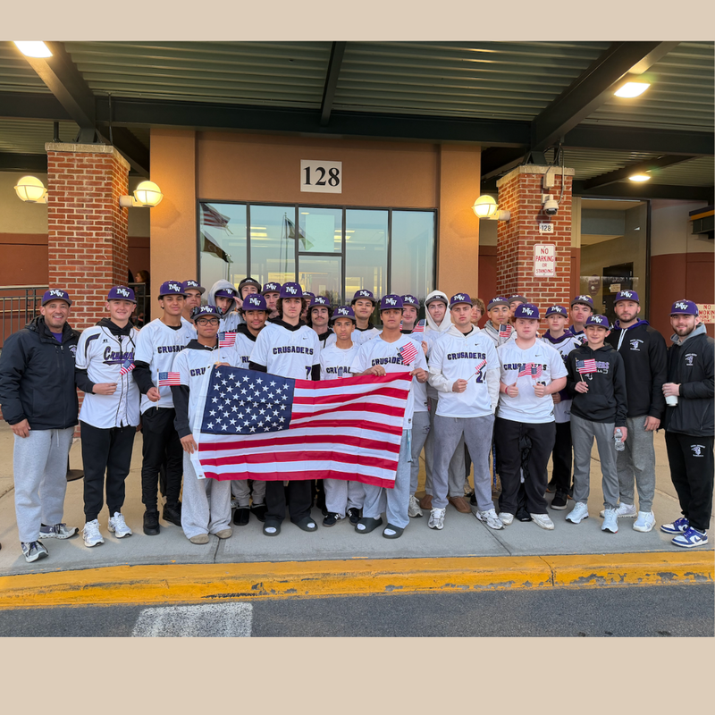Team with white shirts holding American flag