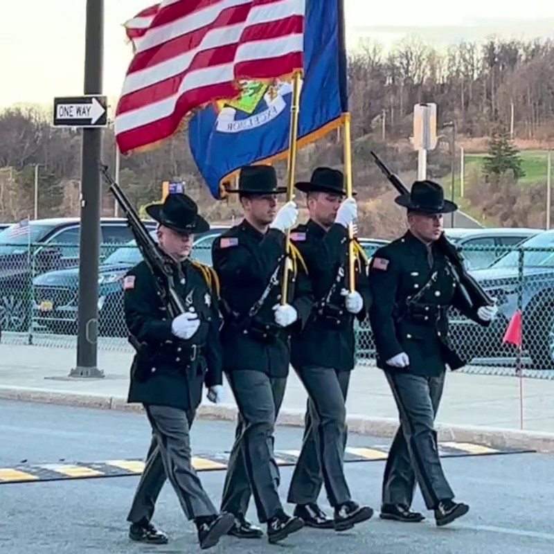 four men standing holding flags