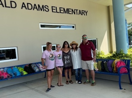 group with donated backpacks