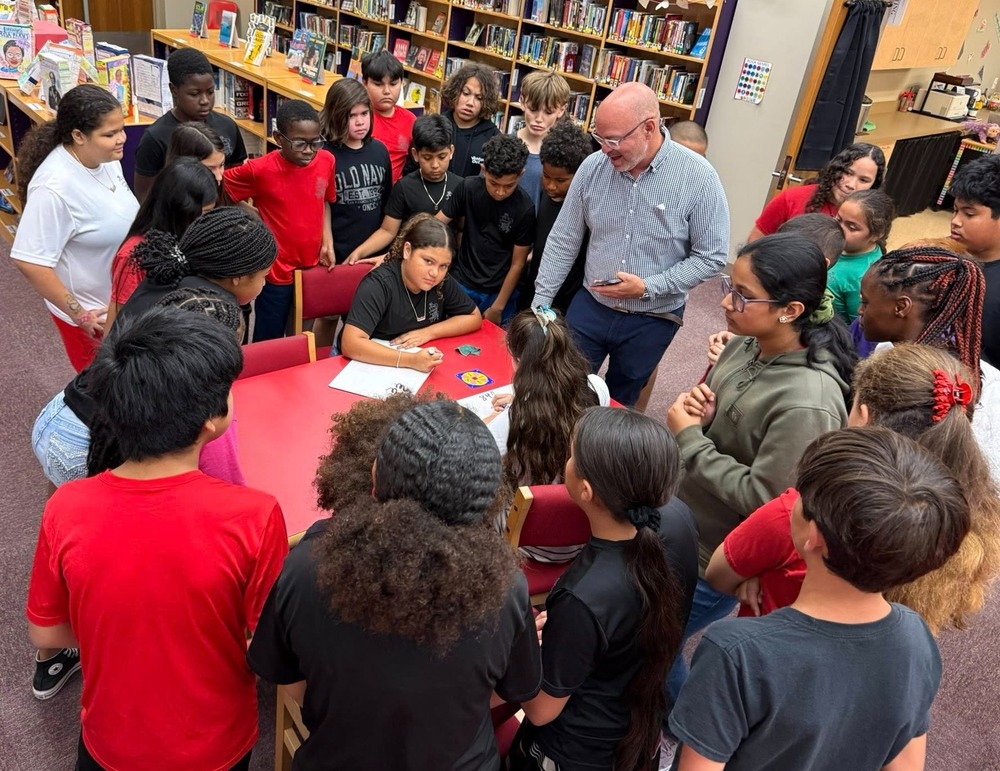 Group of students working with math teacher
