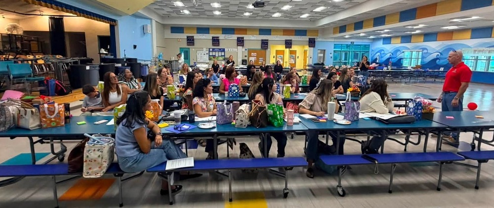 Group of teachers listening to Superintendent Tierney speak