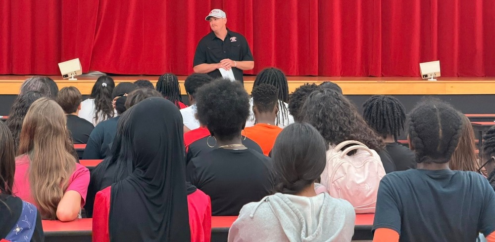 Coach speaking to students