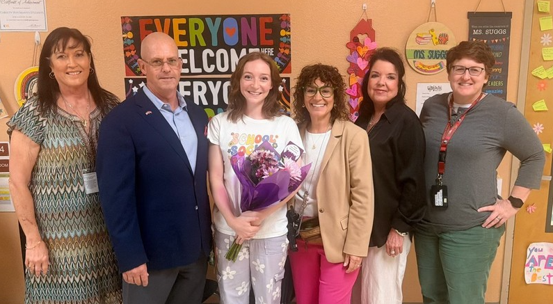 pictured: Ashley Funston with district staff and school principal