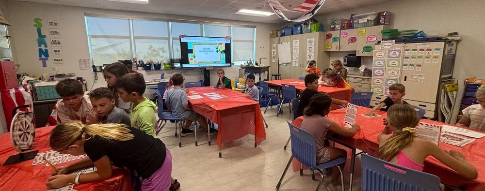 Kids working at tables in a classroom
