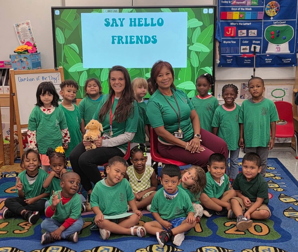 Group of students wearing Green for Start with Hello Week