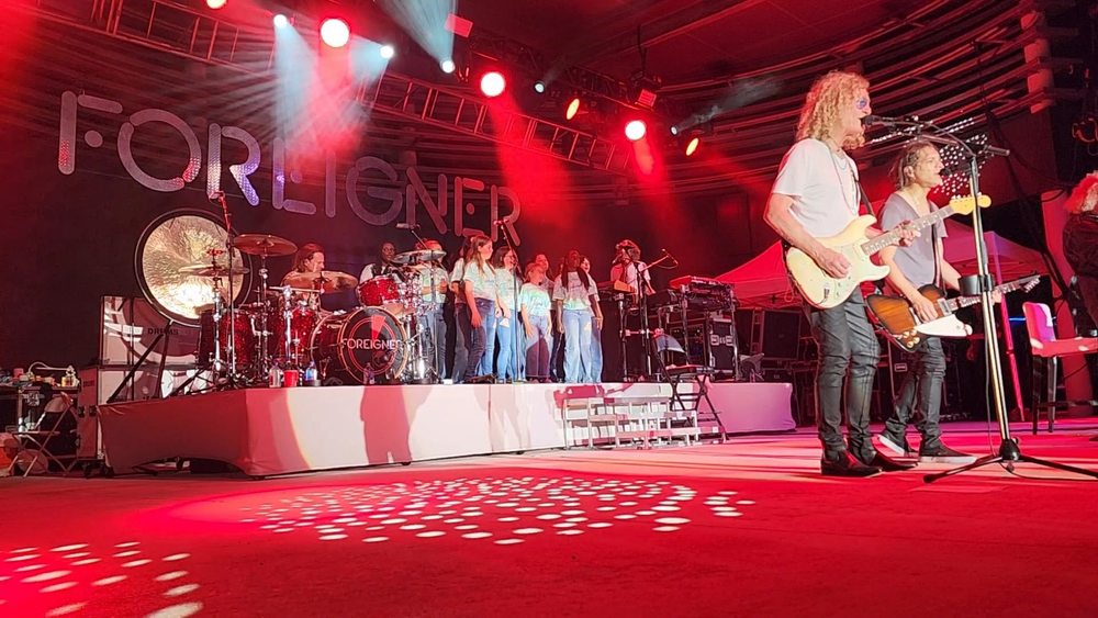 Choir members standing behind band