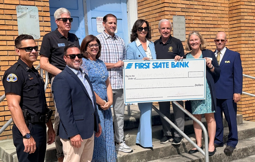 Congressman with school board, accepting check