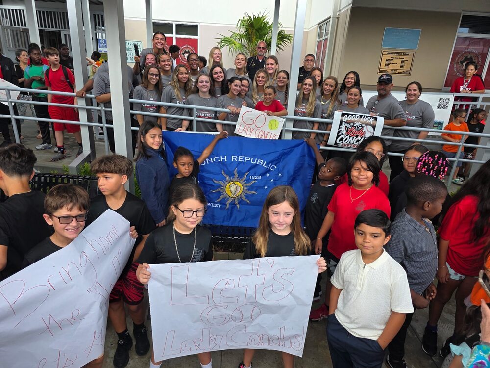 Group of kids with signs supporting Lady Conchs Softball