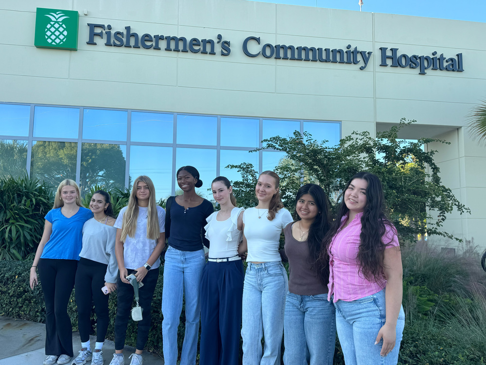 students posing outside hospital