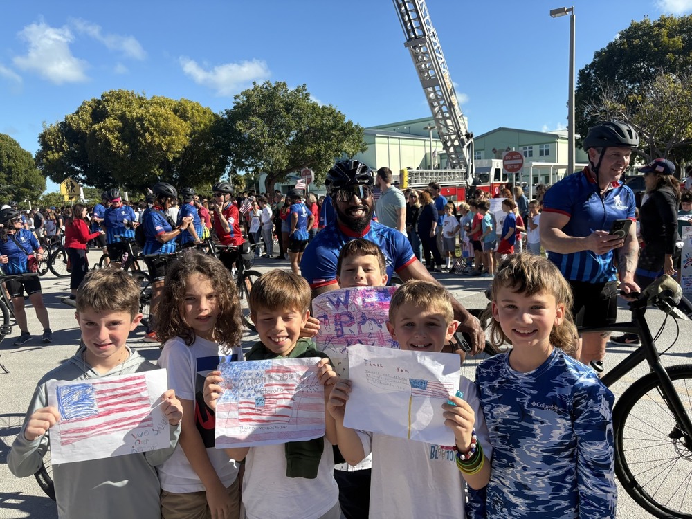 students with wounded warriors and their posters