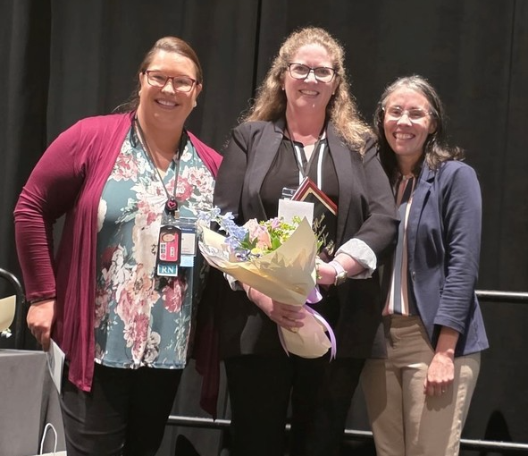 Dana Portillo receiving flowers for health coordinator of the year