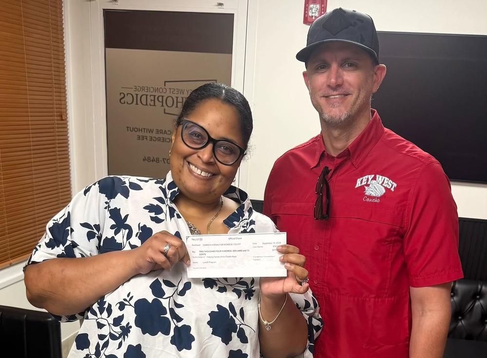 Darren Horan giving check to Helping Hands representative