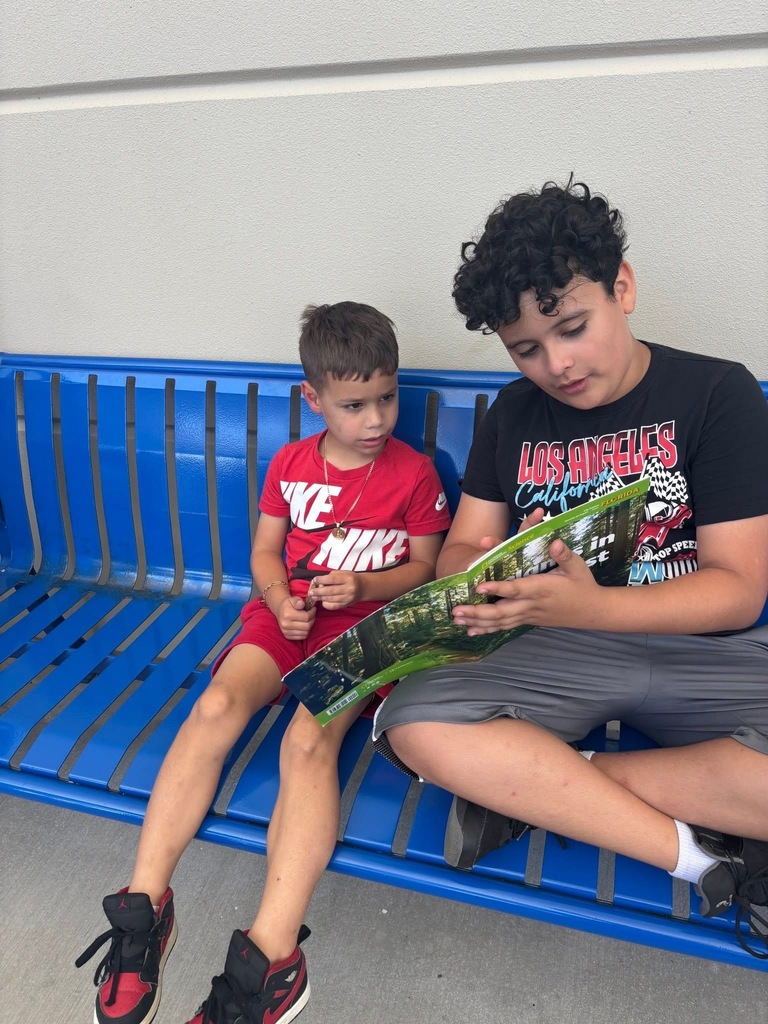 Student collaboration reading with 1st and 5th graders 