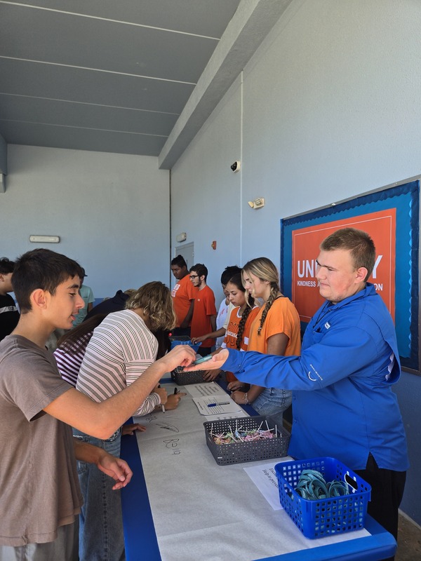 students passing out favors