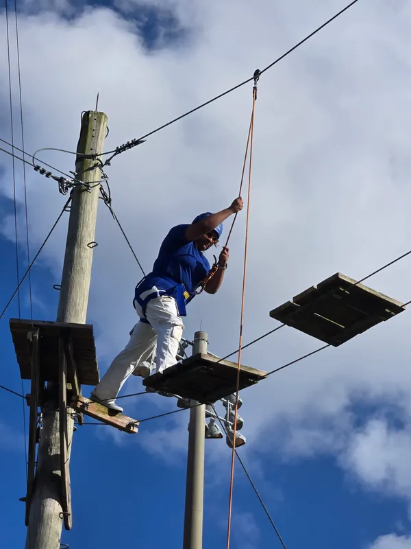 group of students poses at obstacle course