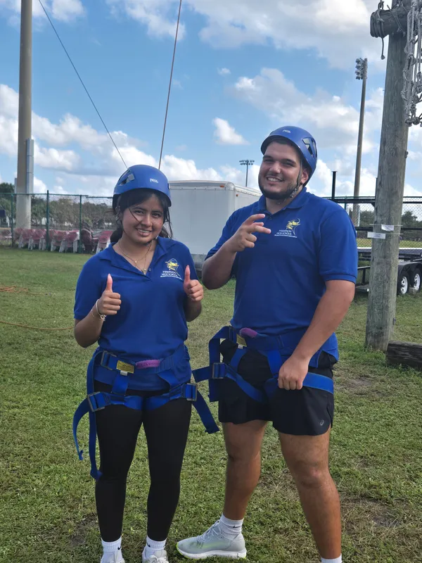 group of students poses at obstacle course