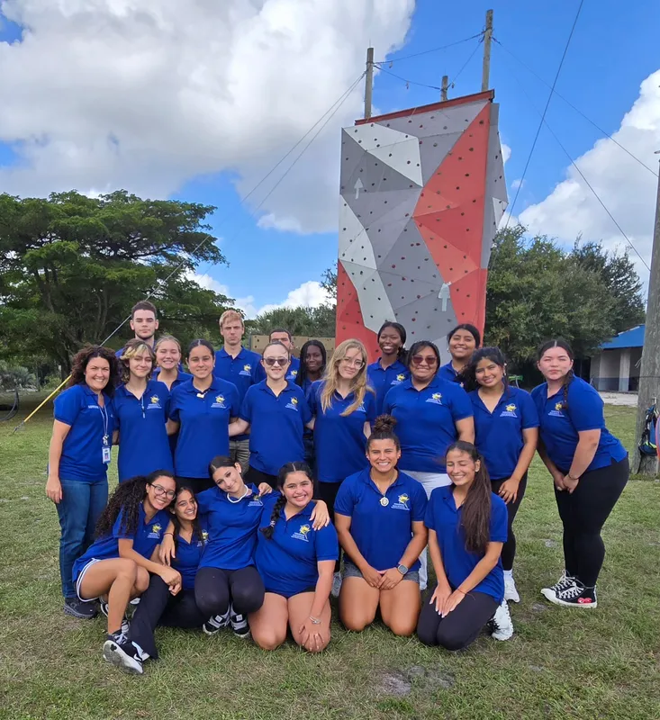 group of students poses at obstacle course