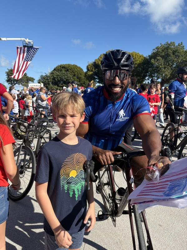 student with veteran and poster