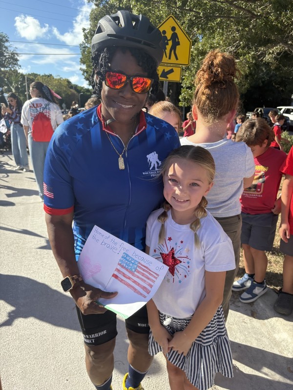student presenting veteran with a picture 