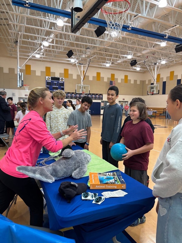 Dolphins plus speaking to students