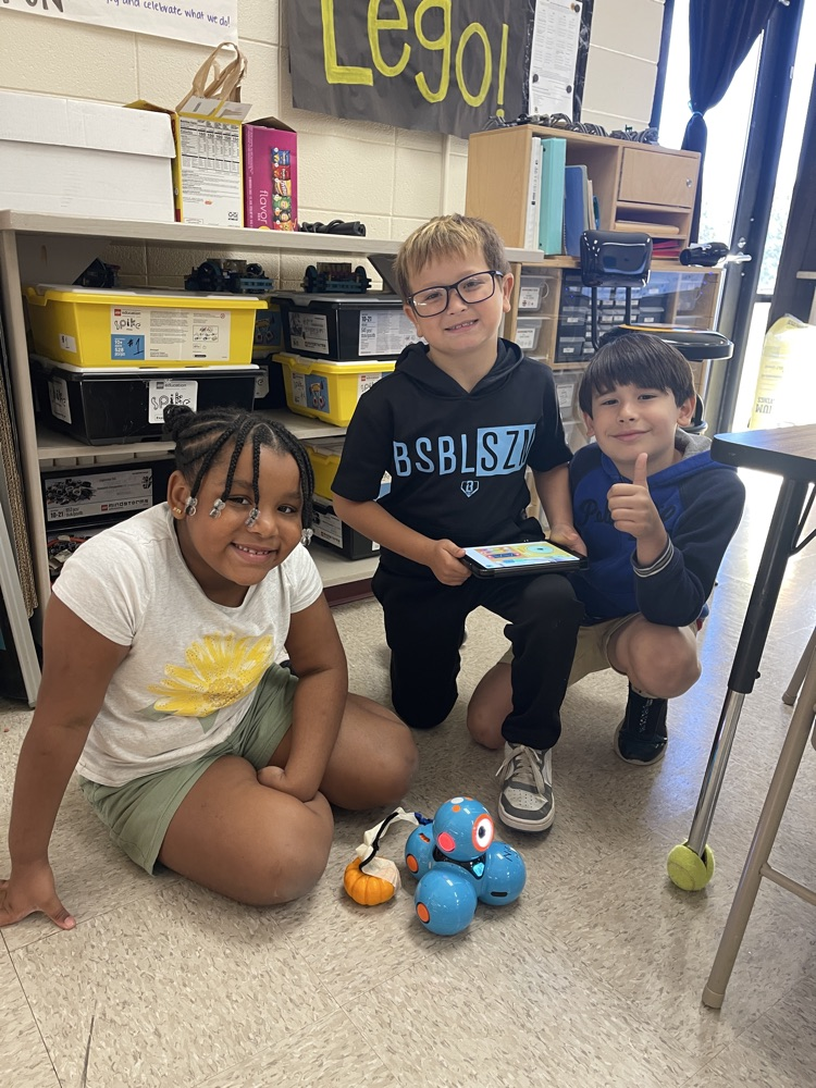 2nd grade students hauling pumpkin with robot