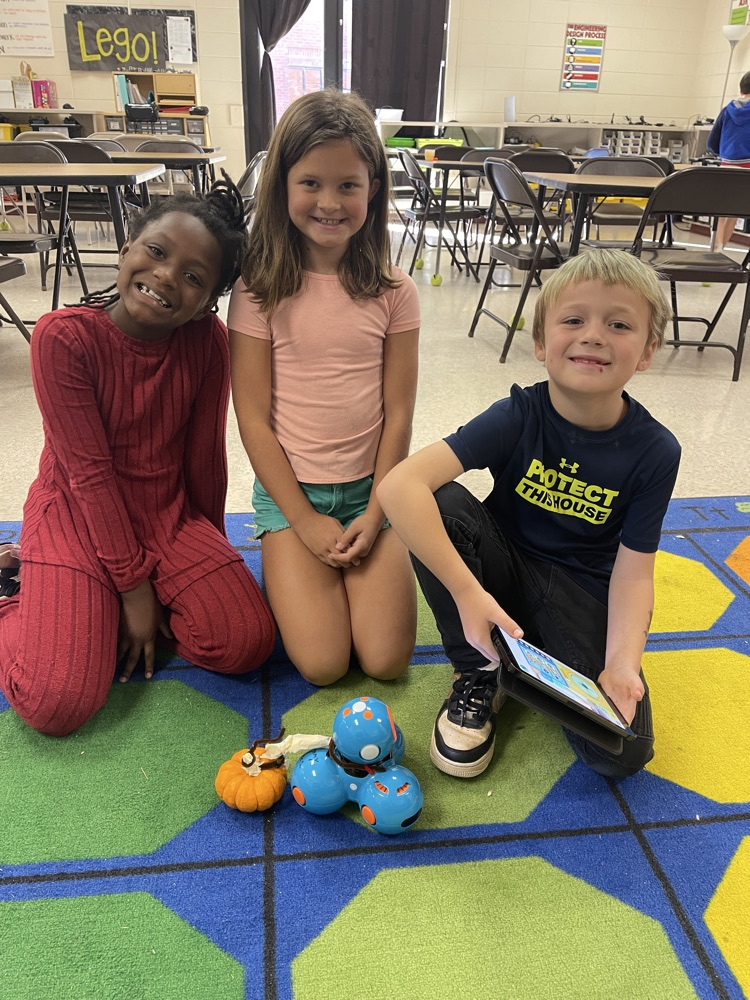 2nd grade students hauling pumpkin with robot
