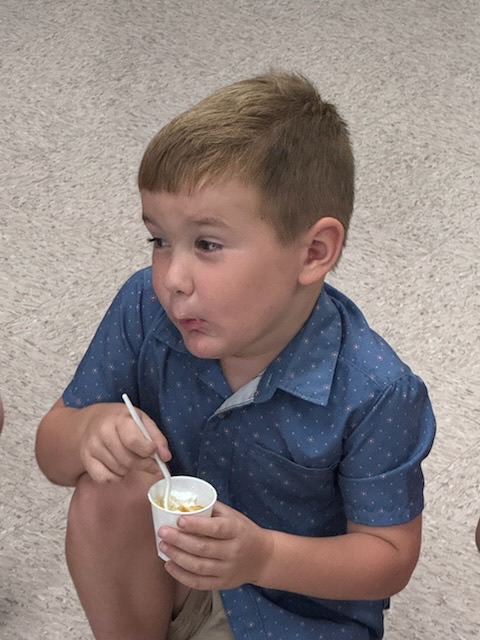 kinder boy enjoying pumpkin pie in a cup