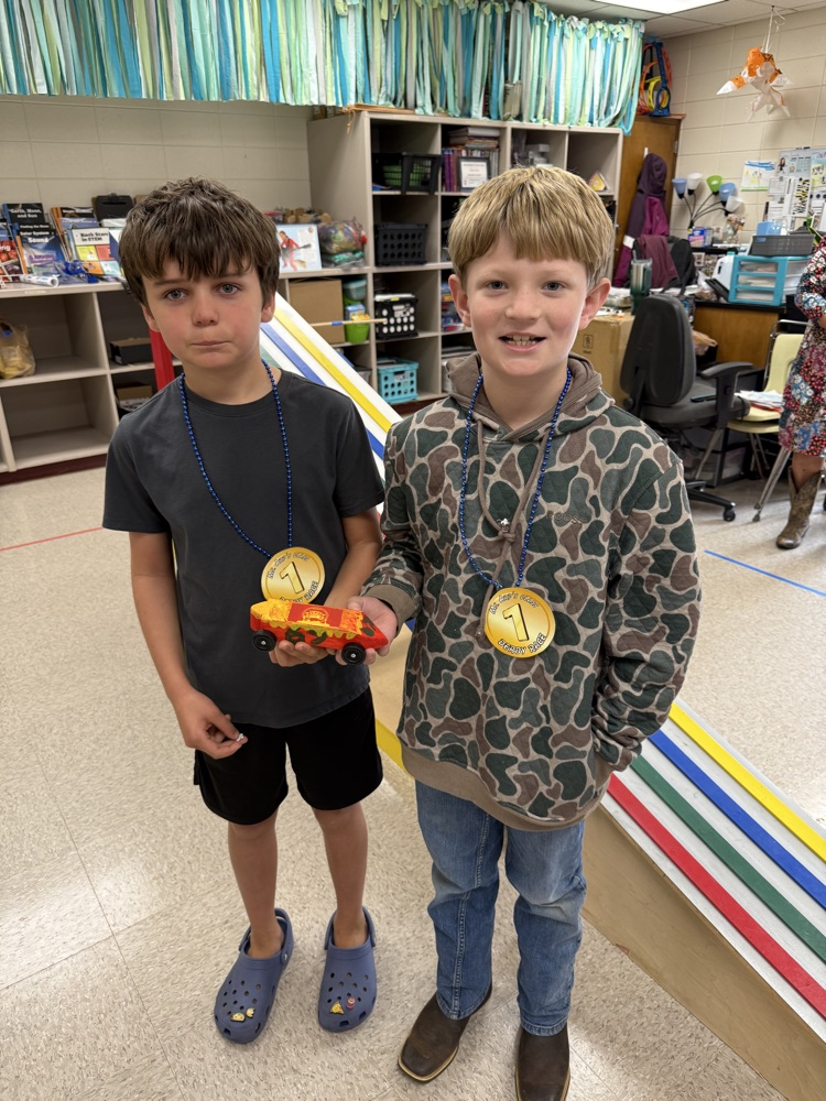 boys holding derby car