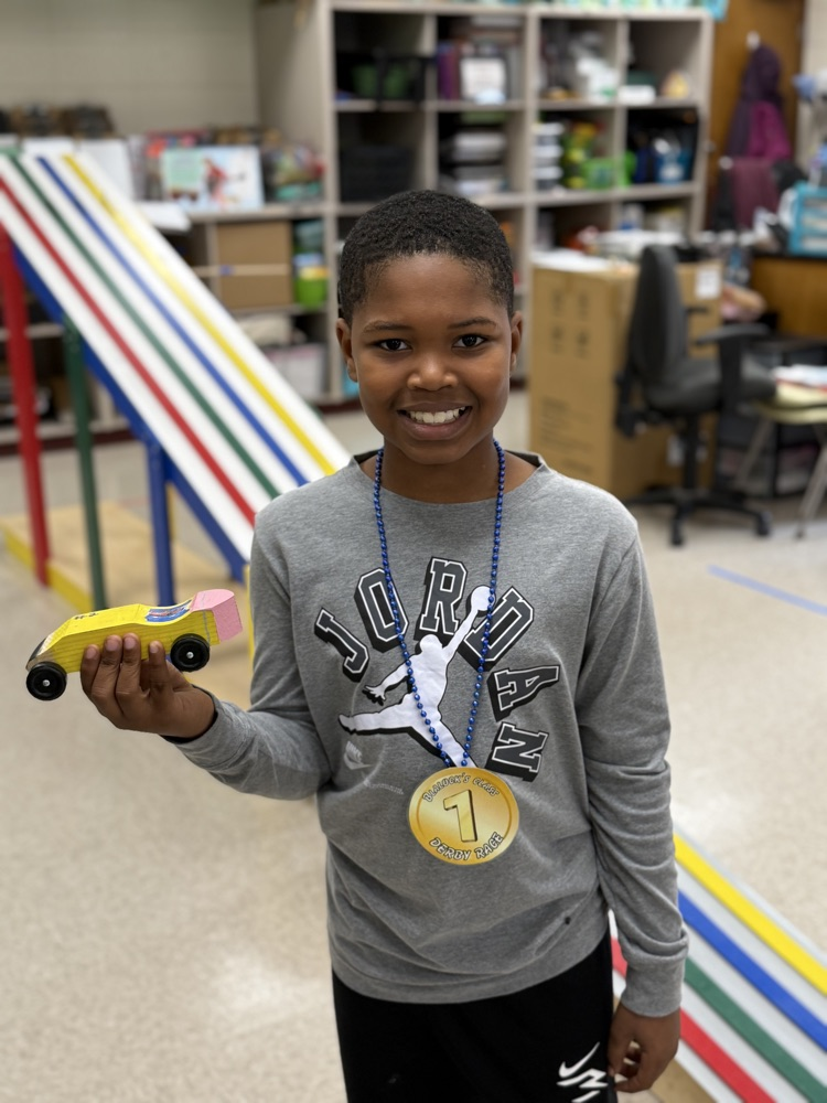 boy holding derby car